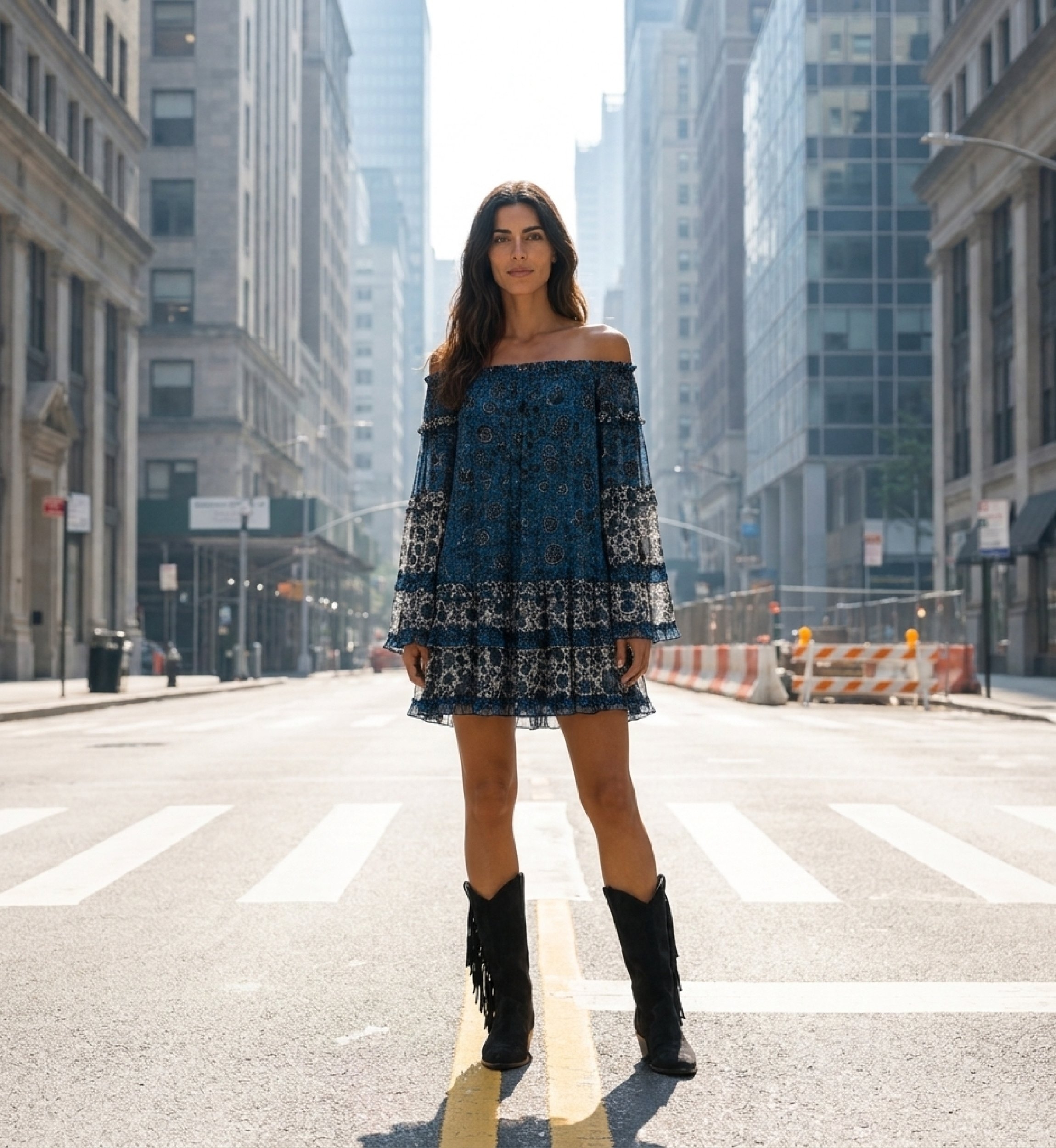 Blue and white off-shoulder mini dress with long sleeves, tiered ruffles, and black floral pattern on sheer fabric. Model in pow
