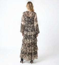 Back view of a black and beige floral print maxi dress with long sleeves, elasticated waist, and tiered ruffled skirt.