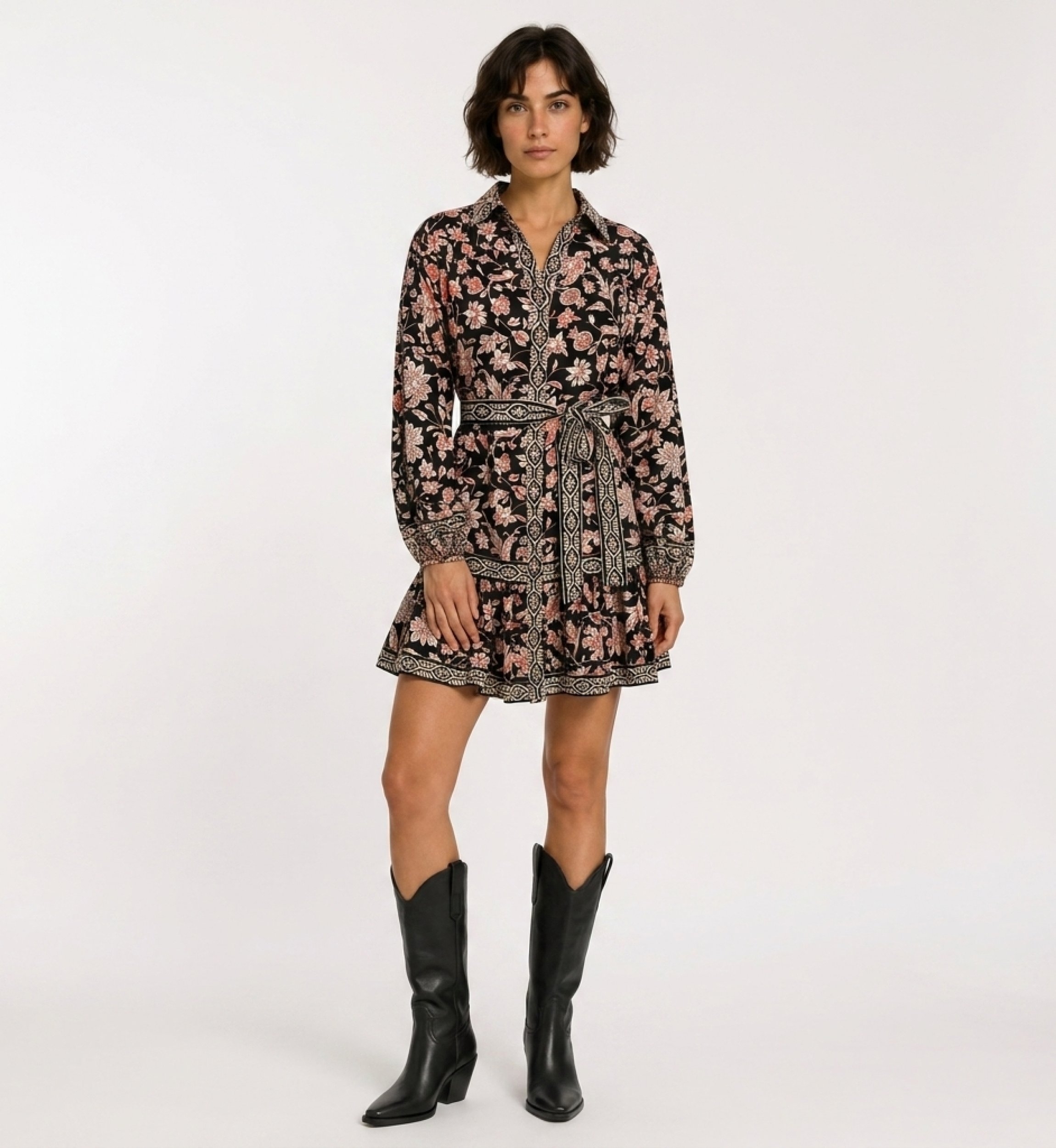 Black long-sleeve mini dress with collar, red and cream floral pattern, tied belt, tiered ruffled skirt, front view.