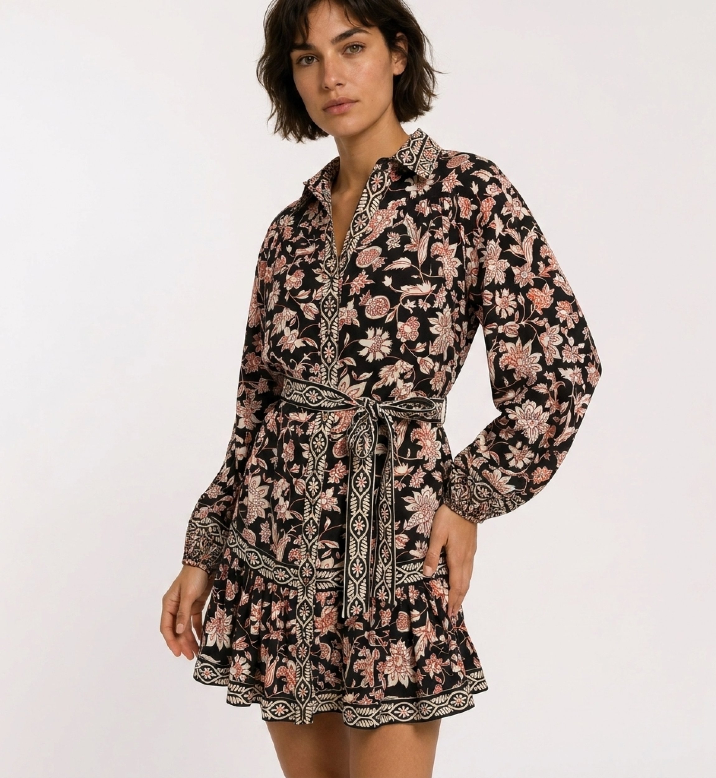 Black long-sleeve mini dress with red & cream floral print, collar, tie belt, and tiered ruffled skirt.