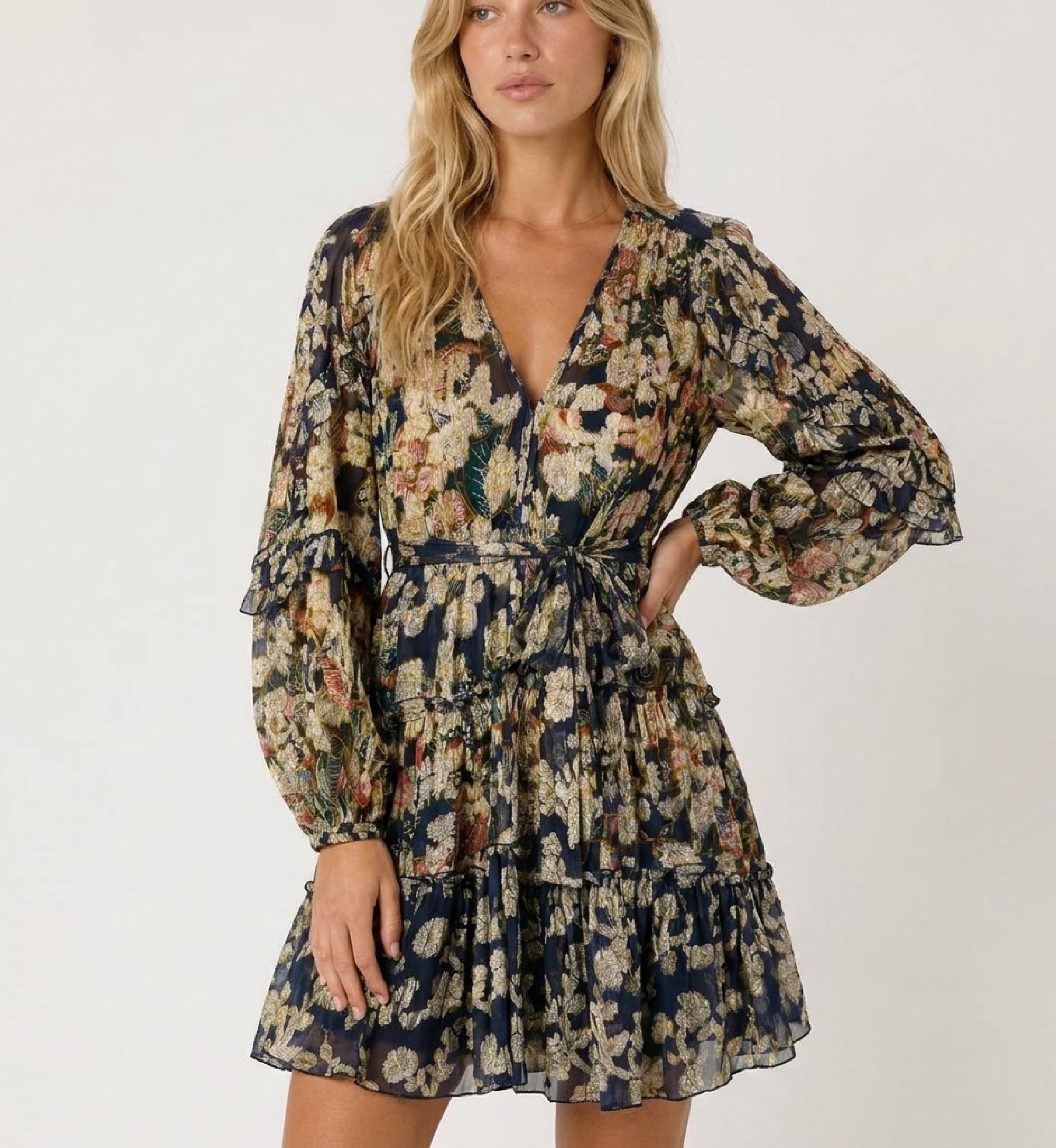 Abito blu navy corto maniche, scollo a V, fantasia floreale oro, gonna a balze, vita con fiocco, tessuto leggero, vista 3/4.