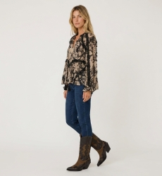 Beige & black patterned long-sleeve blouse with loose fit, ruffled trim, and tassel details, lightweight fabric.