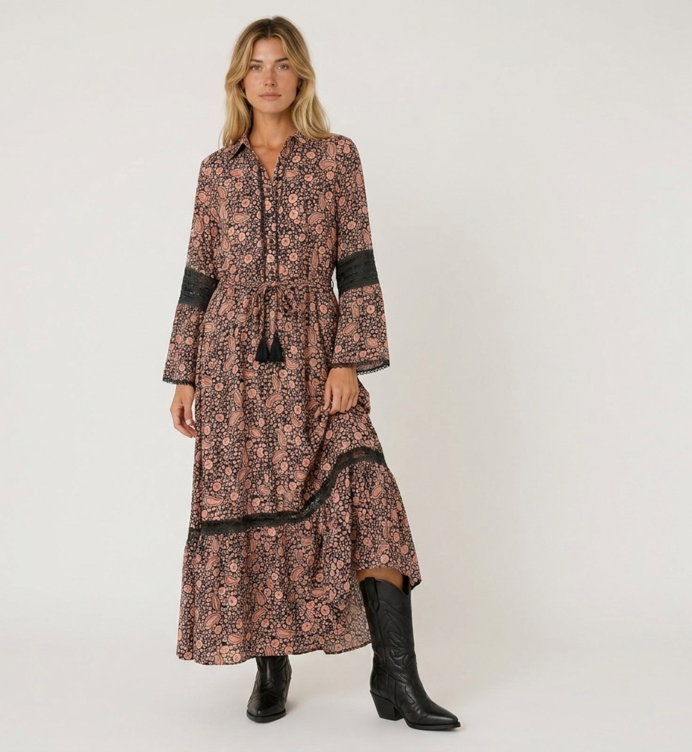 Front view of a long-sleeve black and peach paisley print maxi dress with a collar, smocked waist, and lace trim.