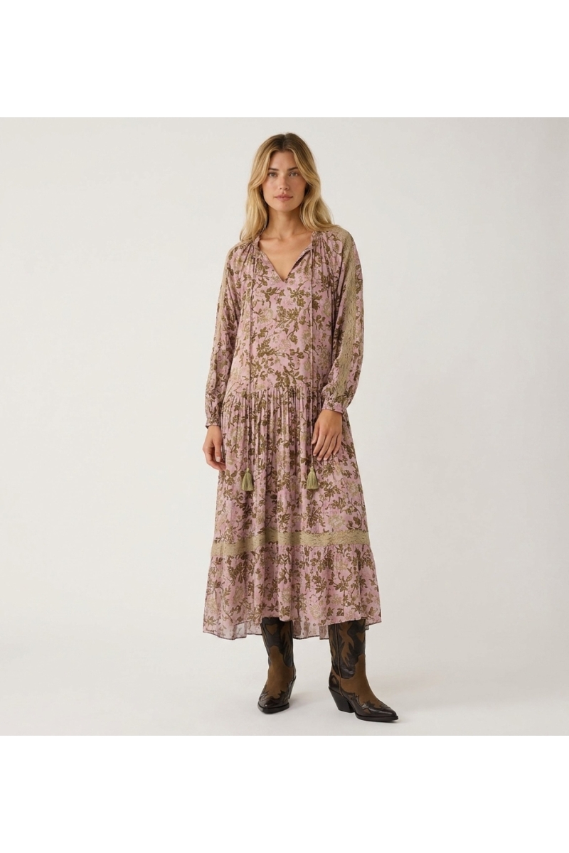 Front view of a lavender long-sleeve tiered maxi dress with dark floral pattern, sage lace, and tassel drawstring neckline.