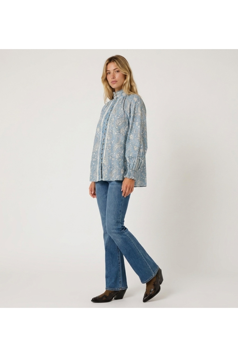 Blouse femme bleu clair manches longues, motif cachemire, col haut, boutonnée, poignets à volants.