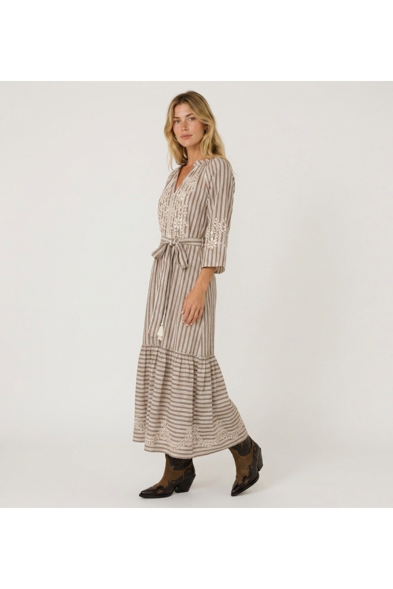 Brown and white striped midi dress with tiered skirt, white floral embroidery, and tie waist with tassels.
