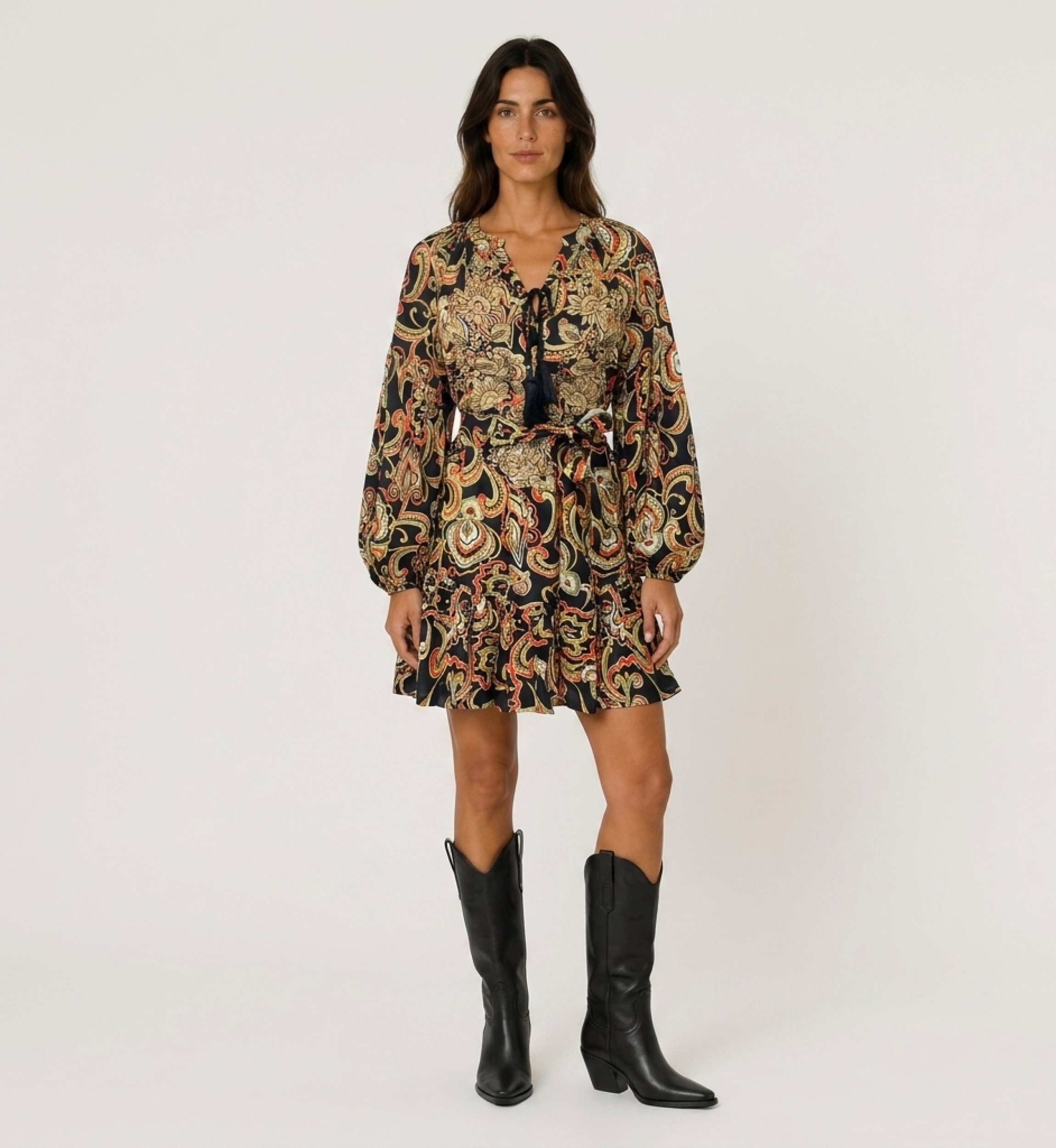 Schwarzes Langarm-Minikleid mit buntem Paisley-Muster, Bindekragen mit Quasten, Taillenschnürung und Rüschensaum, Vorderansicht.