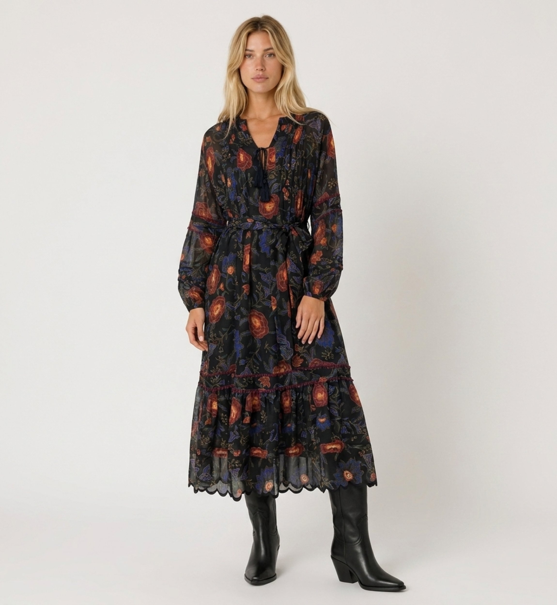 Black midi dress with long sleeves, red and blue floral print, tiered skirt, tie-waist, made from sheer, lightweight fabric.