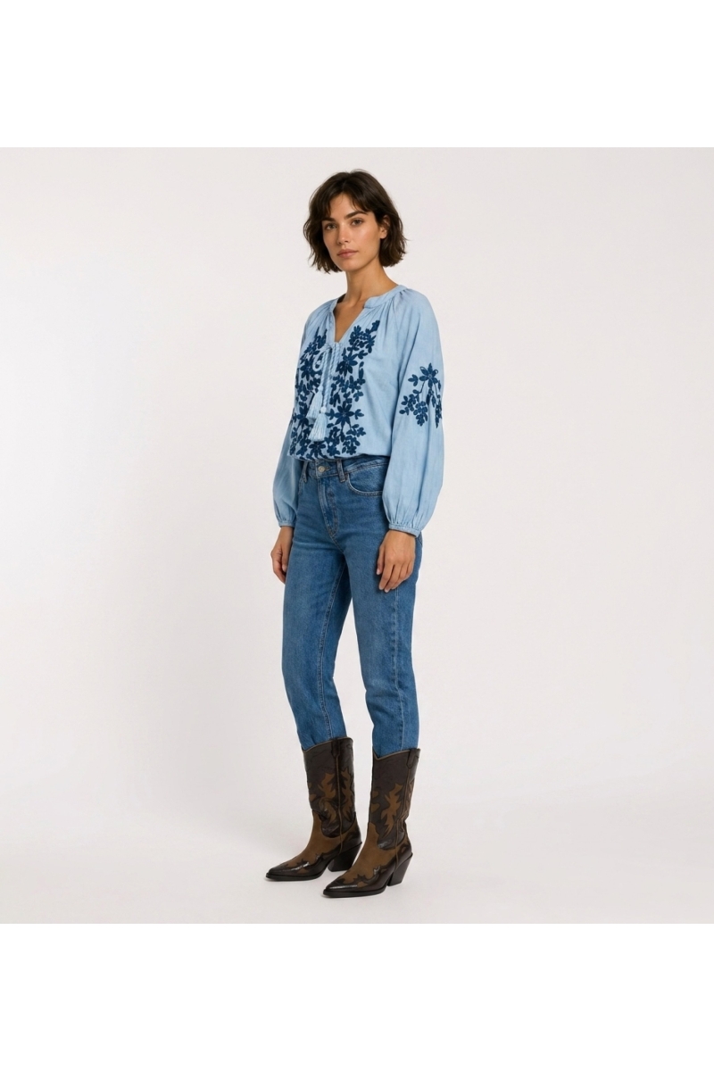 Black long-sleeve peasant blouse, v-neck with ties, cream floral embroidery on linen-look fabric, three-quarter view.