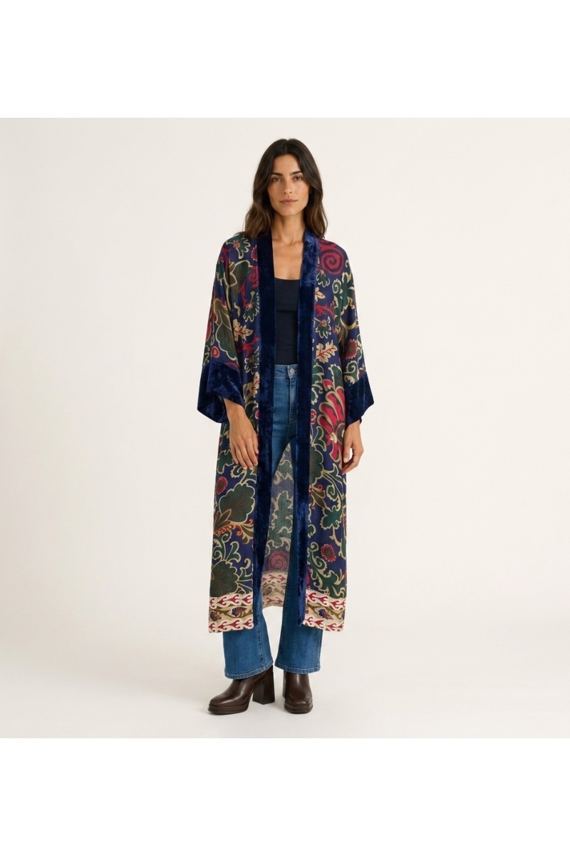 Long burgundy kimono, loose fit, vibrant floral paisley pattern in pink, yellow, blue. Dark red velvet trim, front view.