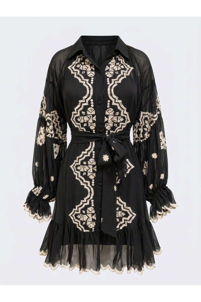 Mini vestido negro con cuello, mangas largas transparentes, bordado geométrico blanco roto, cintura anudada y dobladillo festone